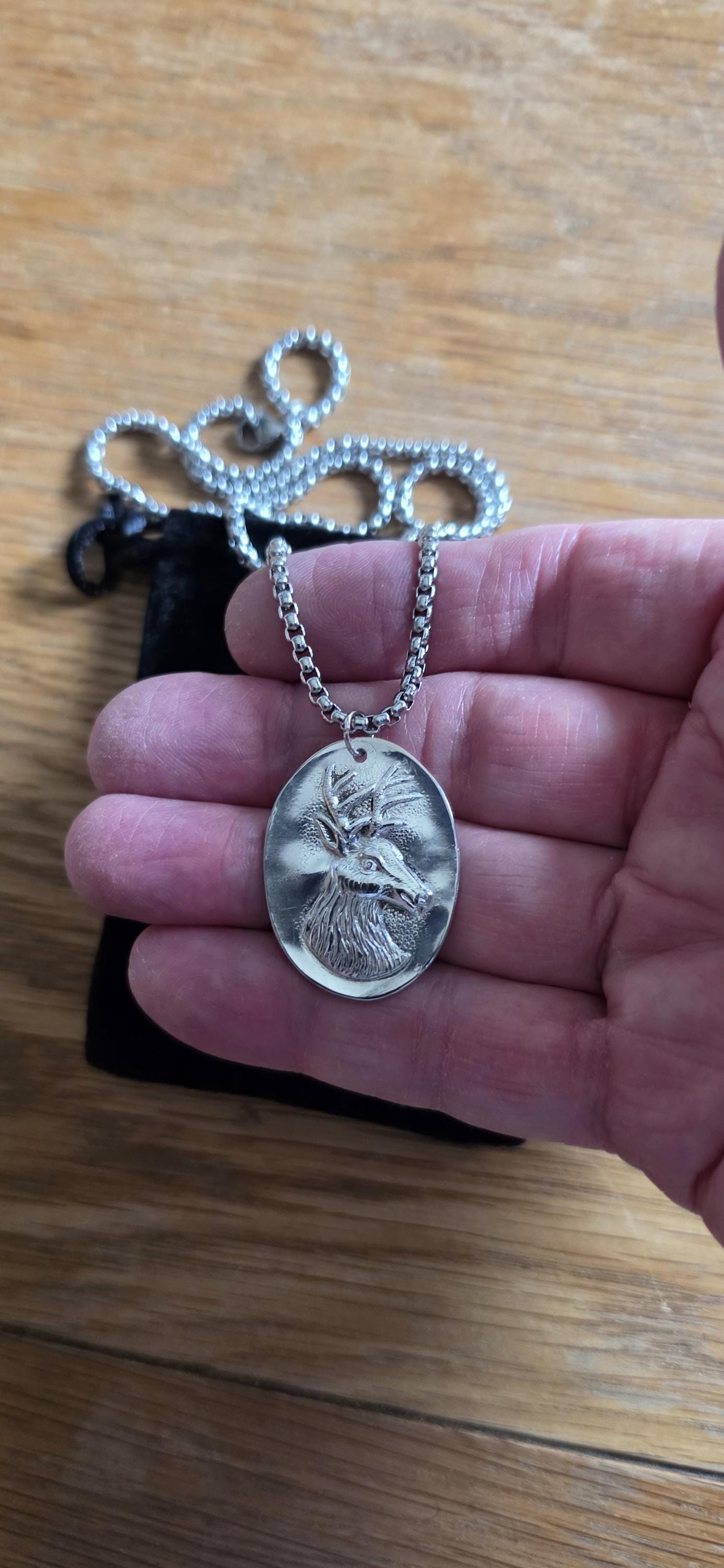 Silver plated spoon featuring stagg head and 20 inch stainless steel chain