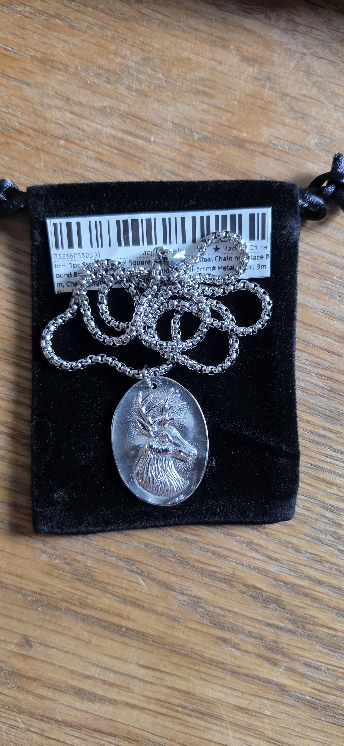 Silver plated spoon featuring stagg head and 20 inch stainless steel chain
