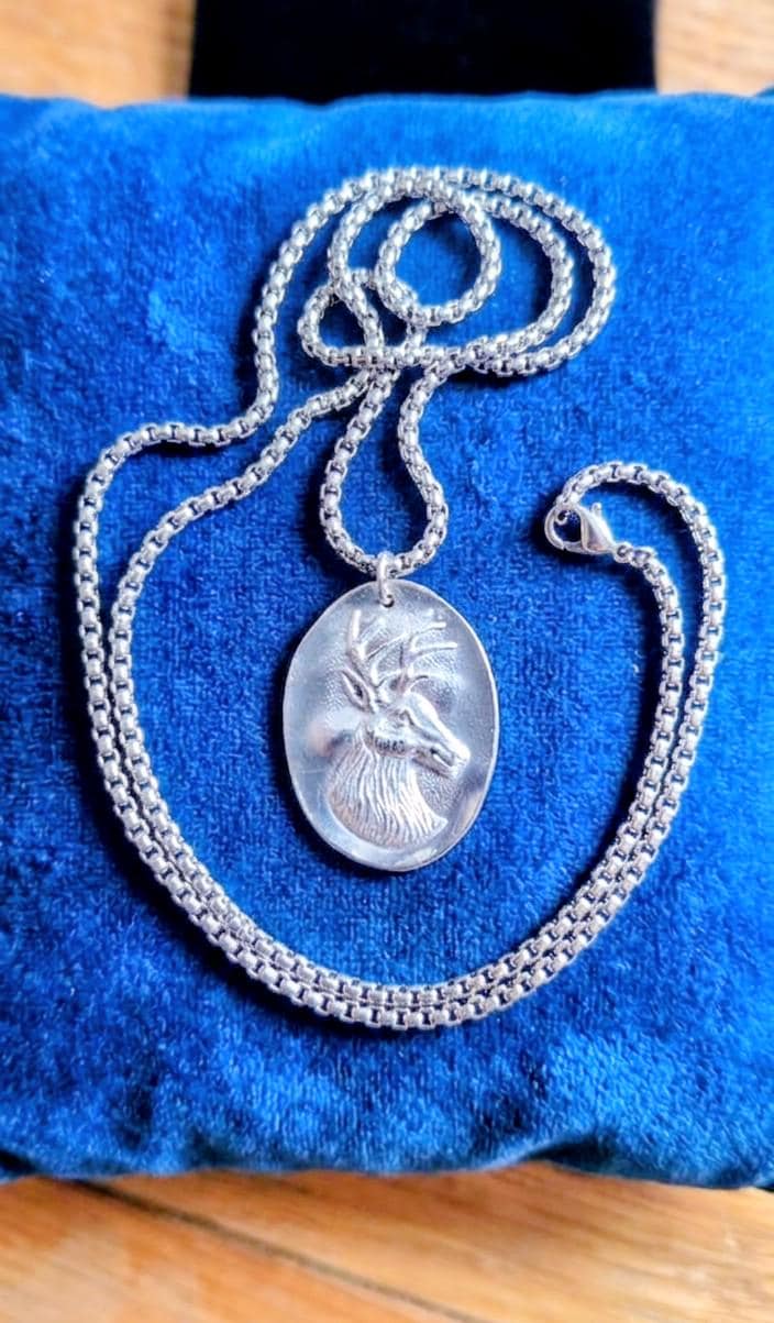 Silver plated spoon featuring stagg head and 20 inch stainless steel chain