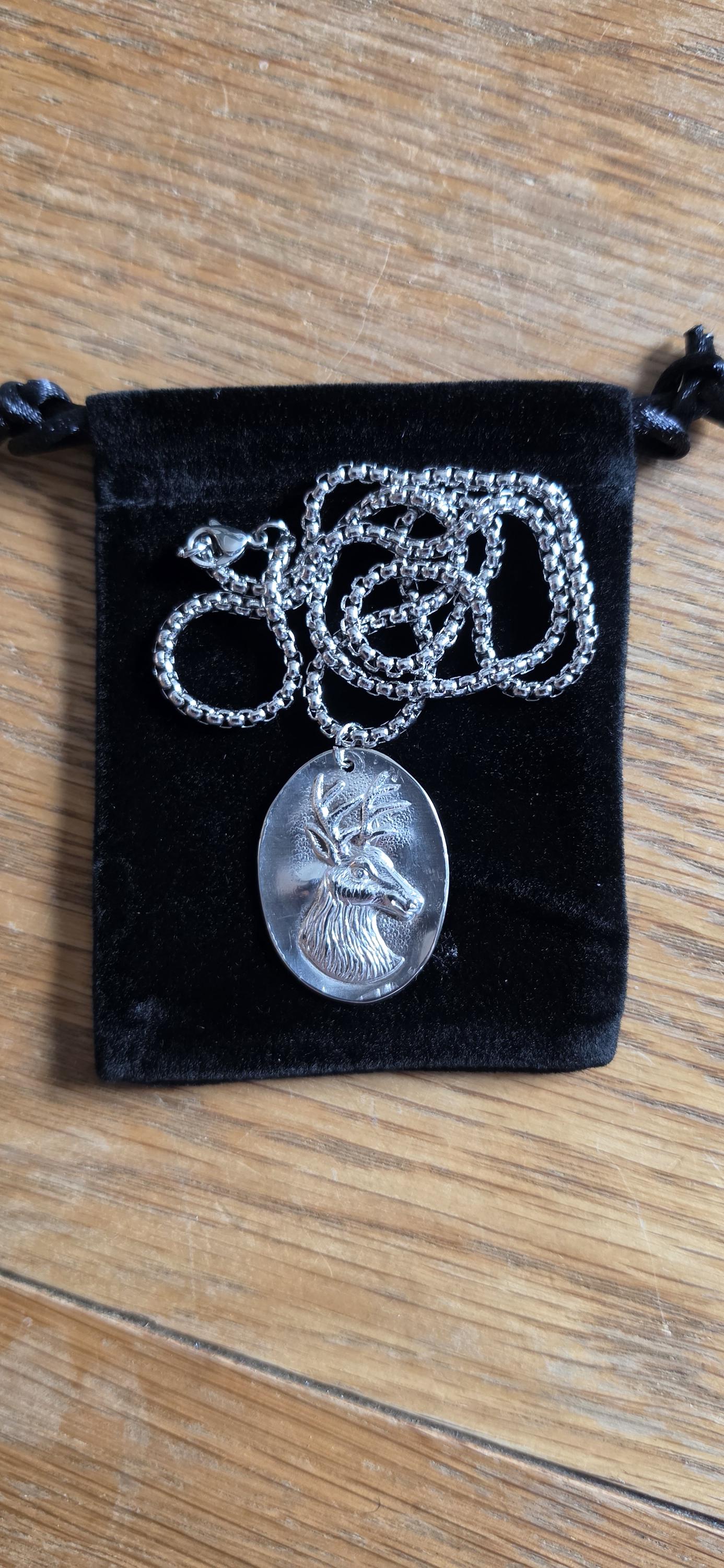 Silver plated spoon featuring stagg head and 20 inch stainless steel chain