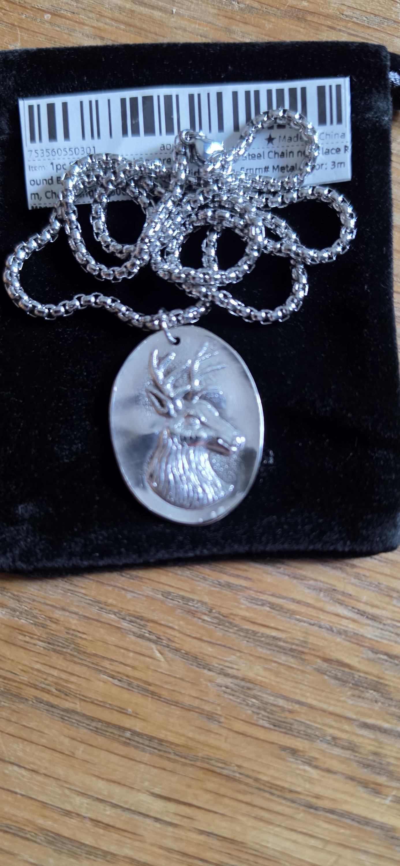 Silver plated spoon featuring stagg head and 20 inch stainless steel chain