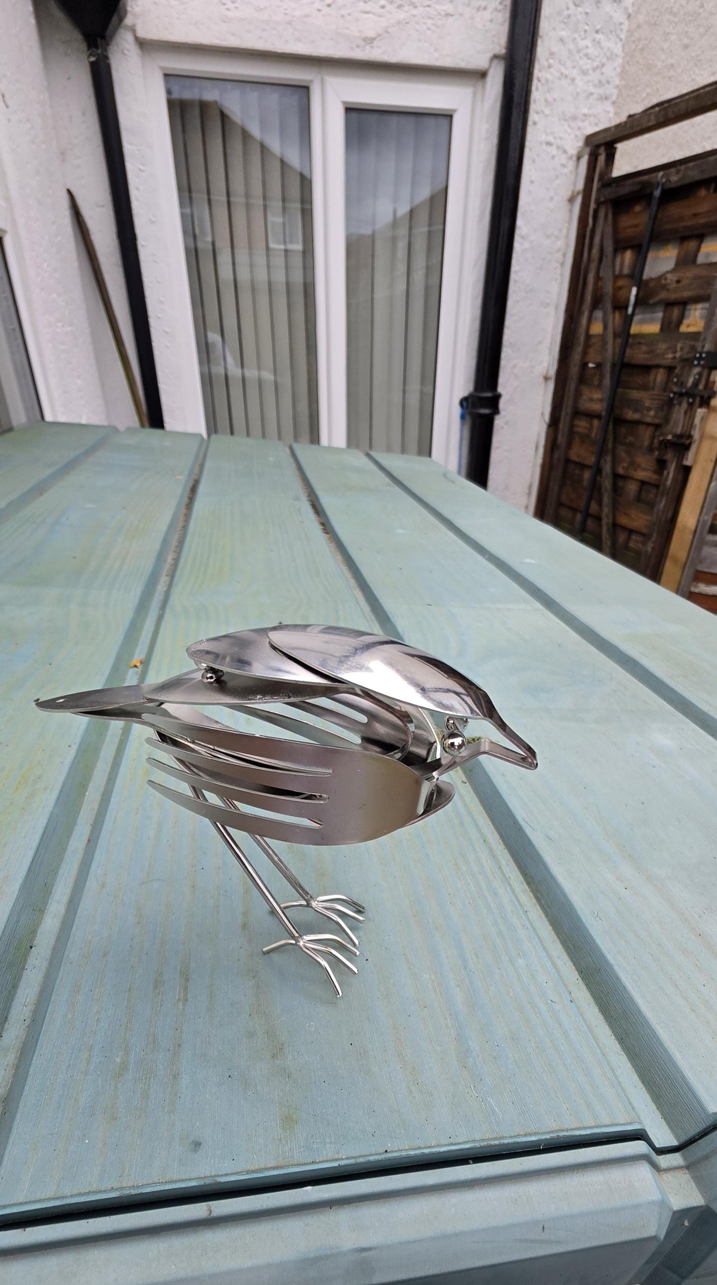 Stainless Steel Robin made from forks, and spoons.