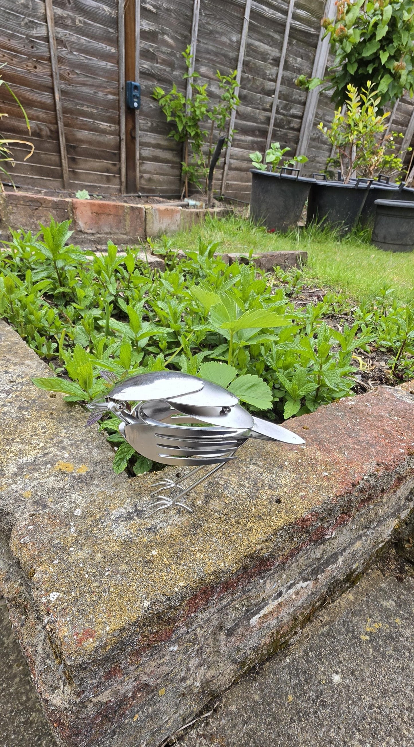 Stainless Steel Robin made from forks, and spoons.