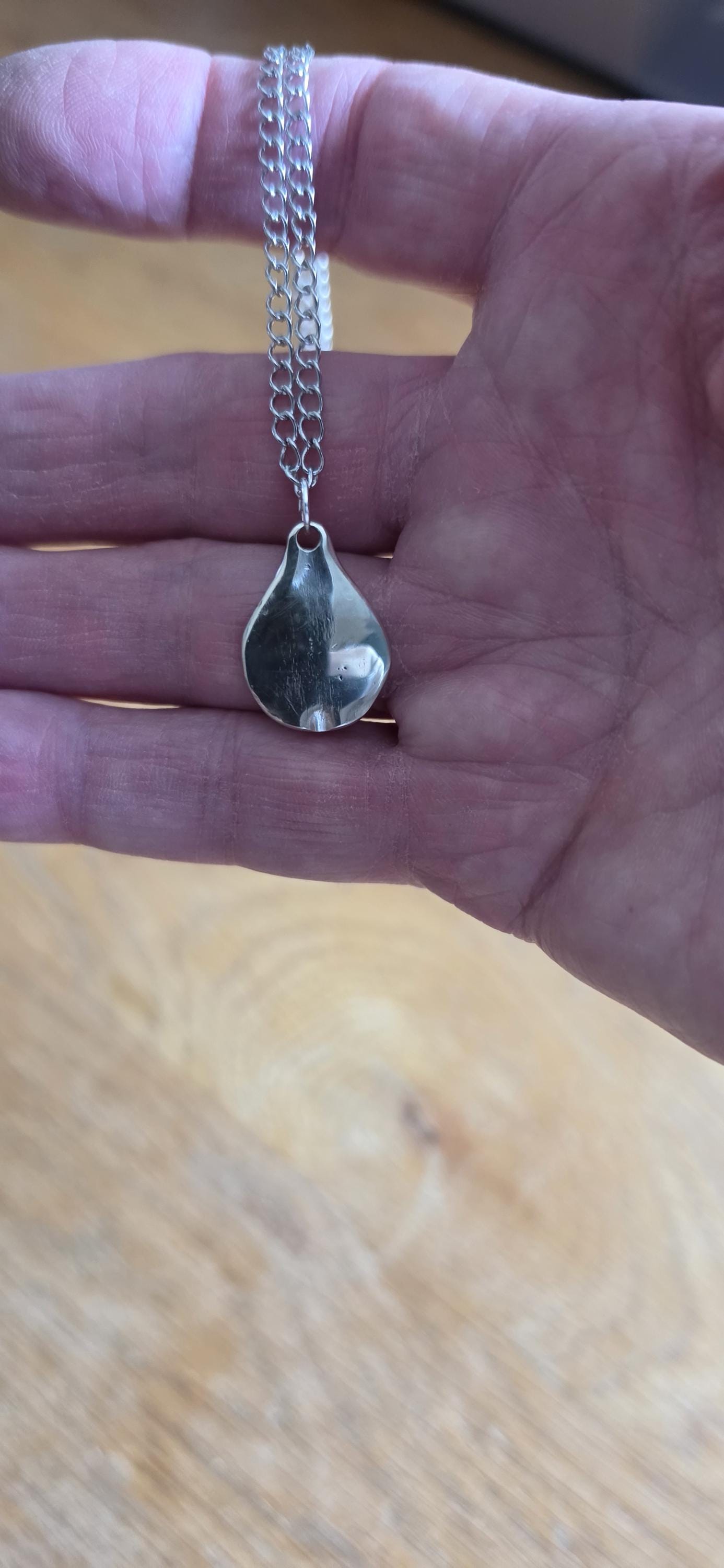 Silver plated fork made into pear shaped pendant with 20 inch stainless steel chain
